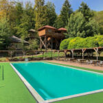 Image of Tree hotel complex with saltwater pool and water slide at the tree hotel in Bad Gleichenberg